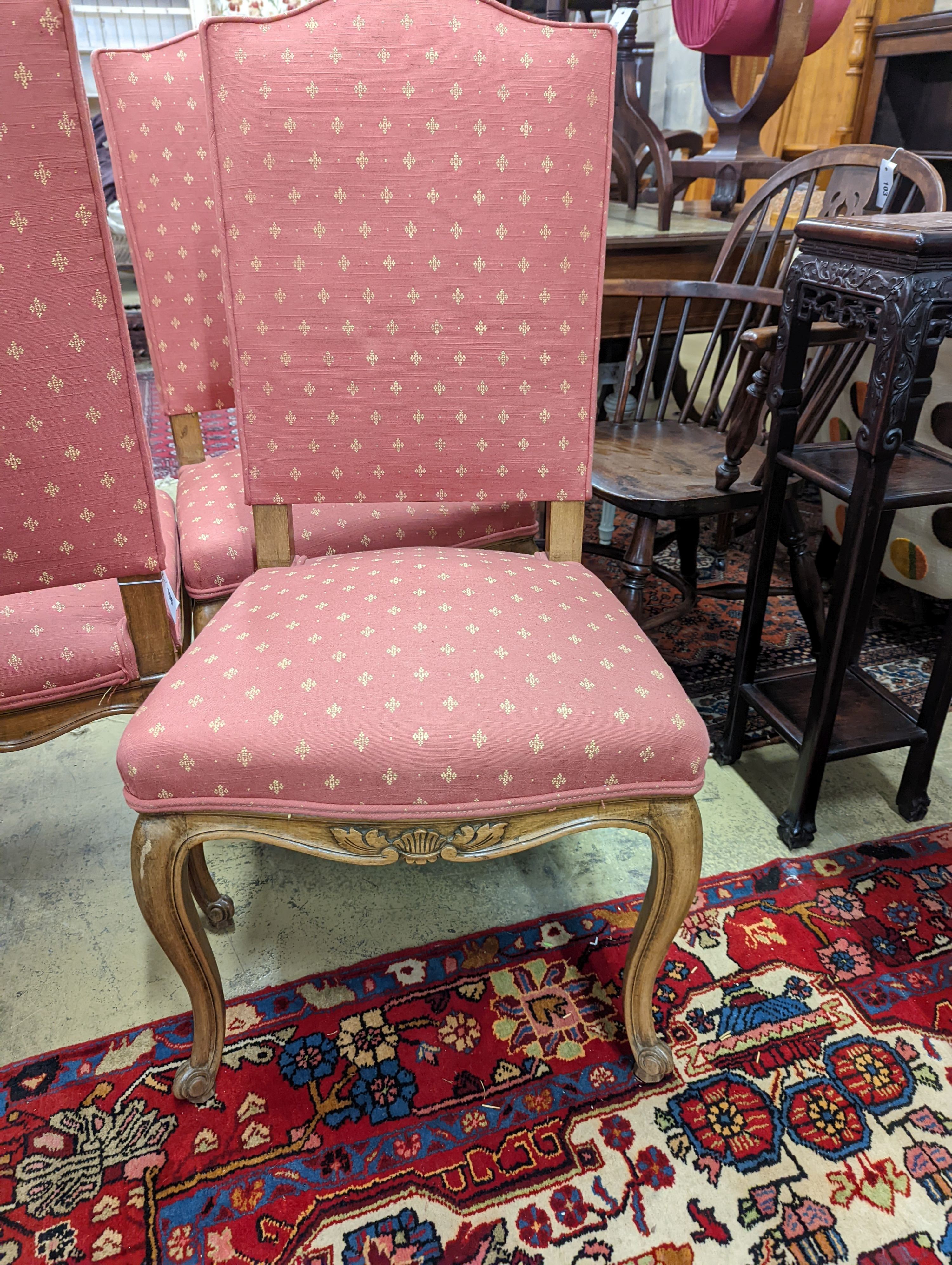 A set of eight French walnut dining chairs